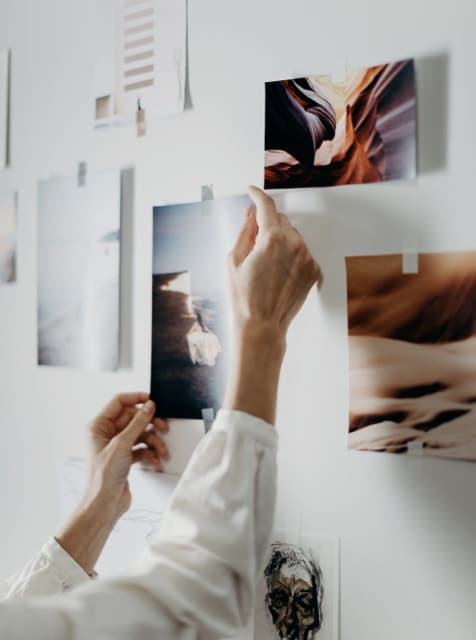 a lady pinning design ideas to the wall